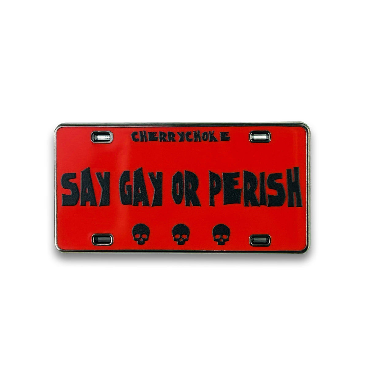 Red “Say Gay or Perish” license plate-inspired enamel pin with black lettering and three skulls, by Cherrychoke.